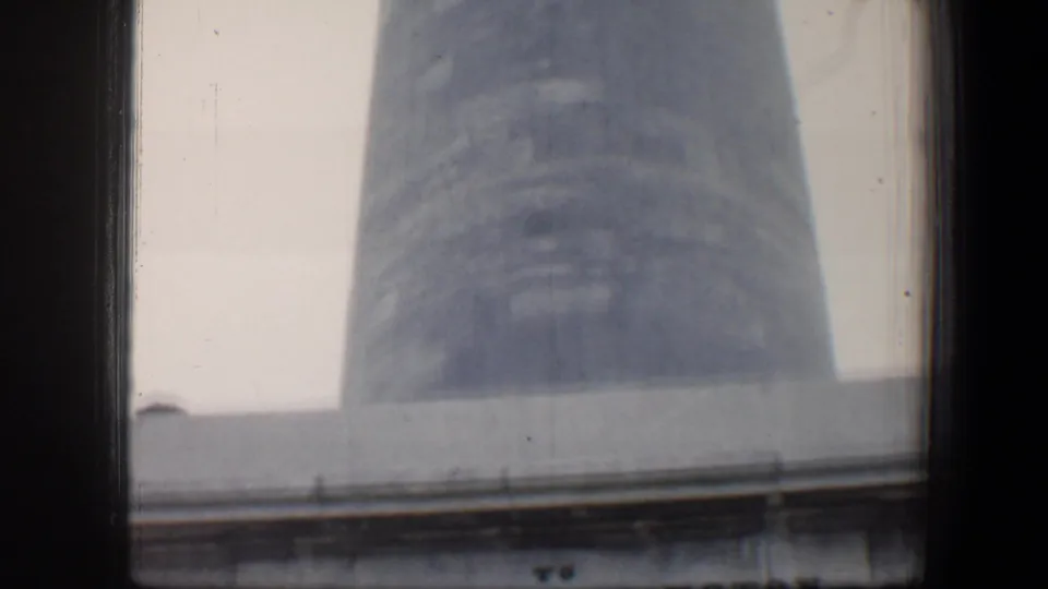 Upward view of the Baltimore George Washington Monument with the inscription mostly leaving frame as the obelisk dominates the shot.