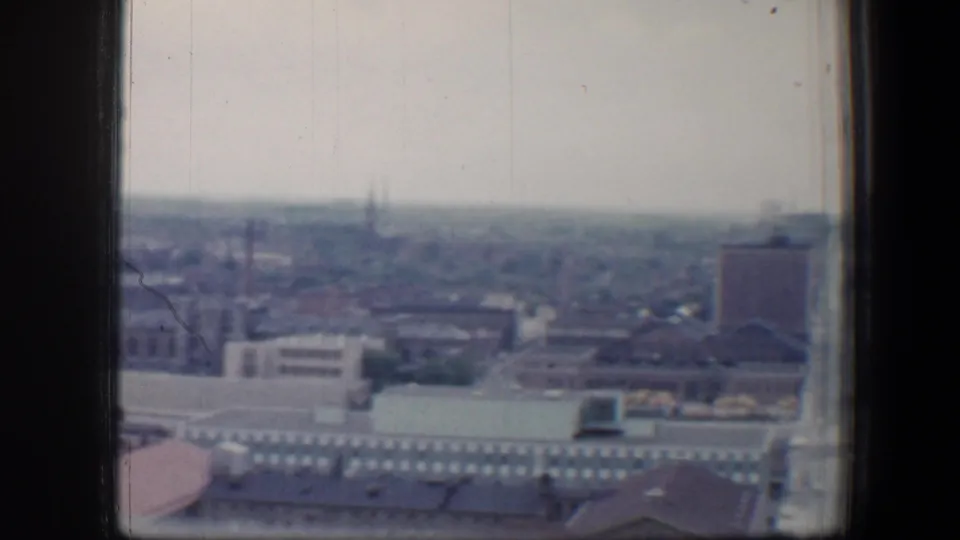 Late frame of the 1960 Baltimore panorama, with rooftops, industrial-looking buildings, distant spires, and window borders visible.
