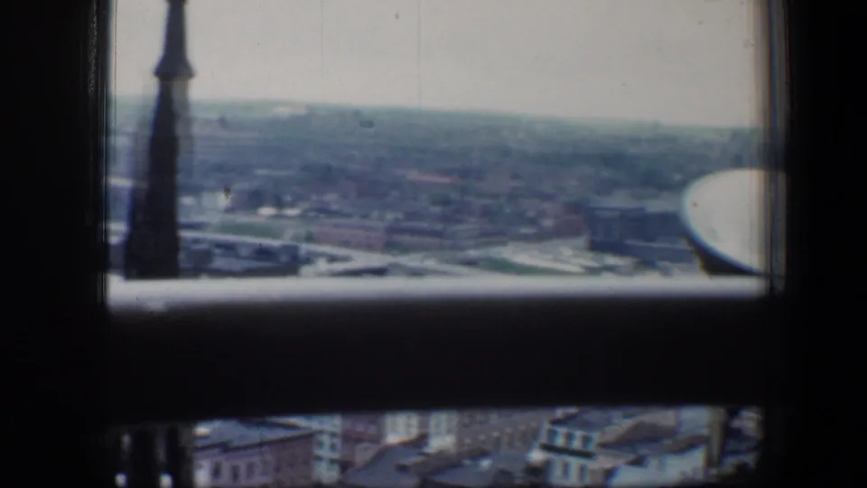 The 1960 Baltimore view continues with a steeple at left, low urban blocks in the distance, and soft 8mm color.