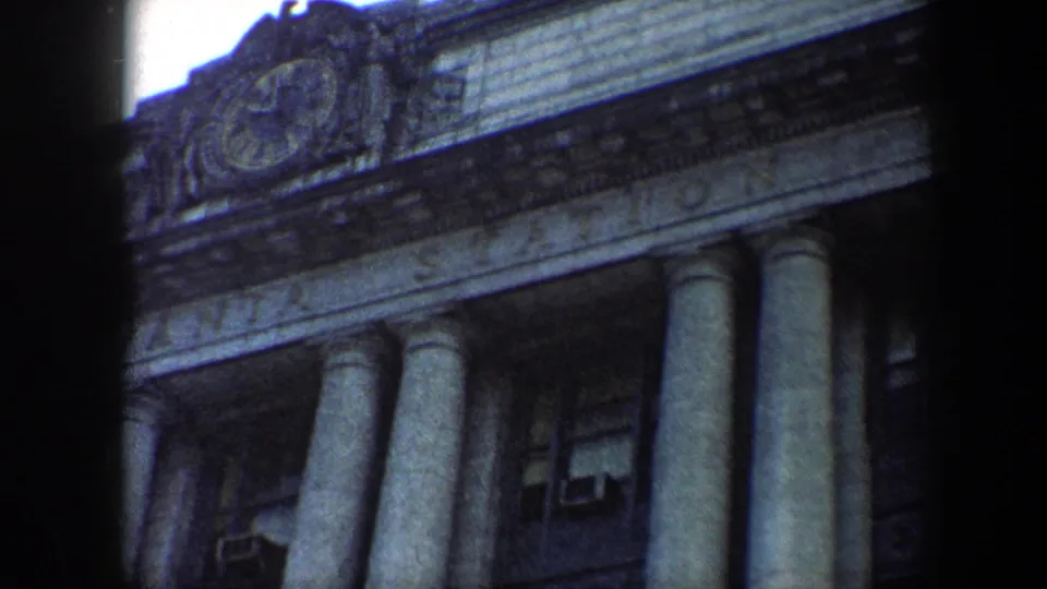 Angled 1960 home-movie view of Pennsylvania Station in Baltimore, emphasizing the columns and upper carved facade detail.