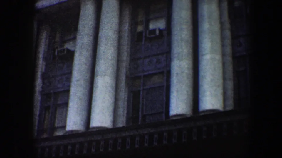 Baltimore station facade in 1960, showing multiple large columns, recessed windows, air conditioners, and a dark lower ledge.