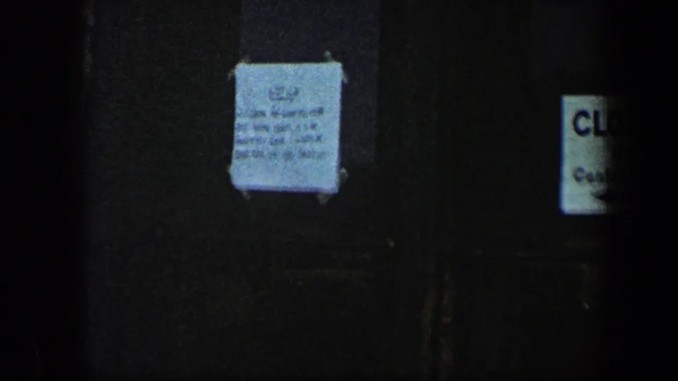 Closer 1960 Baltimore view of taped information on a dark door, with part of a CLOSED sign visible nearby.