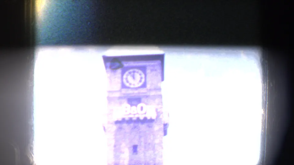 Overexposed Baltimore view of the B&O clock tower, with the clock face and lettering partly washed by blue flare.