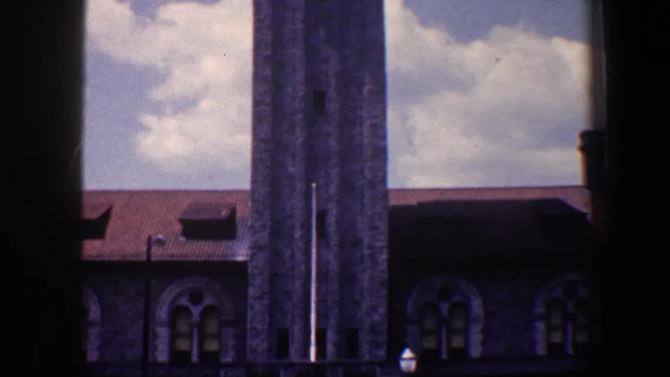 1960 Baltimore 8mm view showing the tower, arched windows, red roof, and heavy dark vignetting from the film frame.