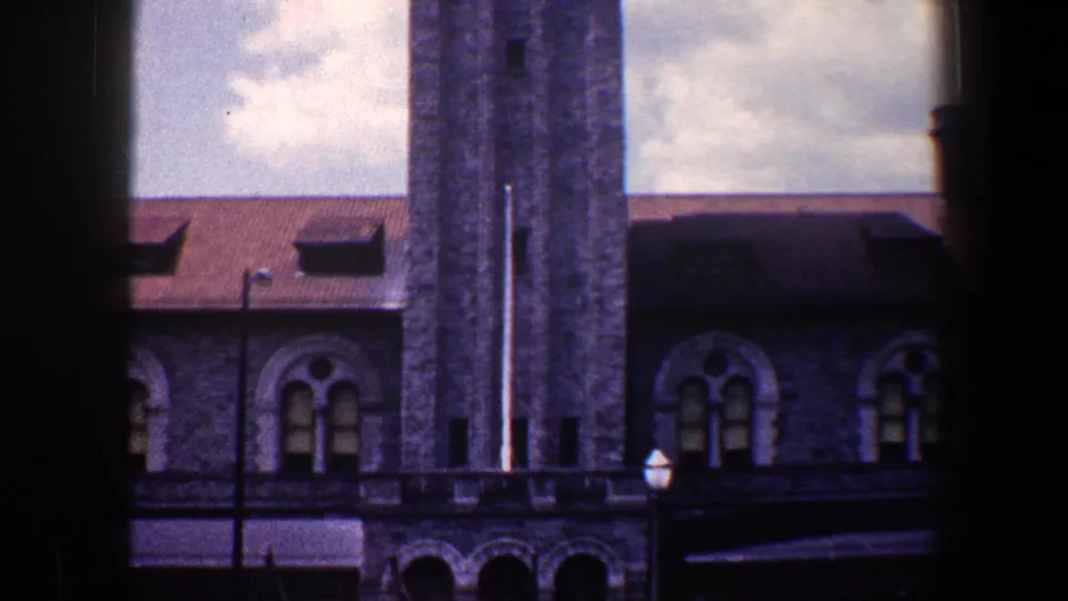Wider 1960 Baltimore view of the B&O-associated tower and adjoining arched-window building, with a streetlamp near the lower frame.
