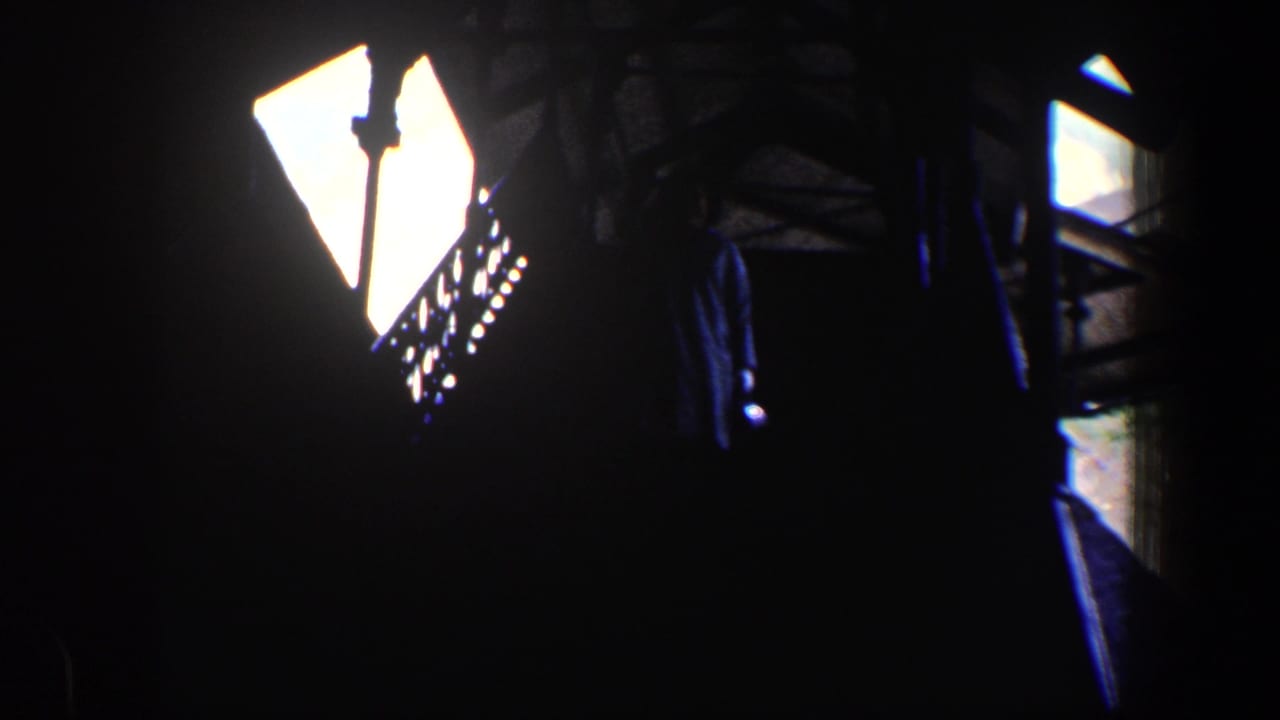 Dark interior with bright backlit window or doorway beside a stair railing.