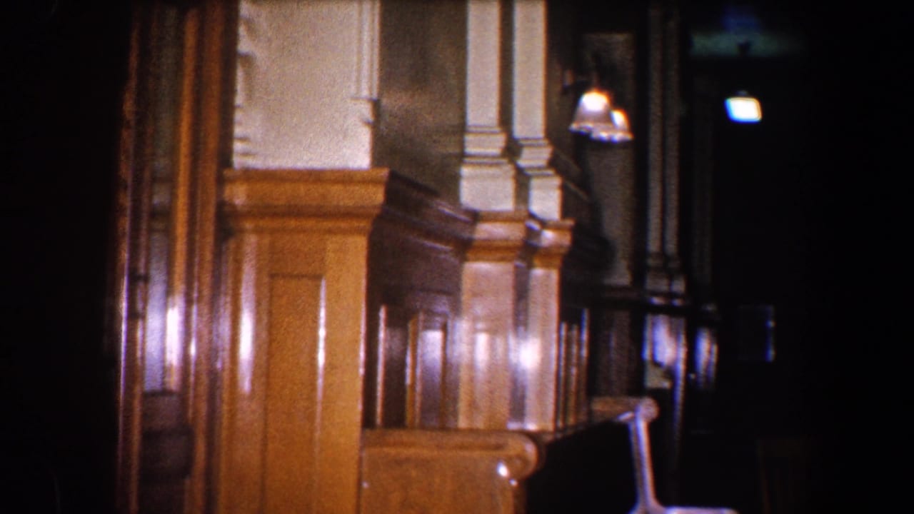 Similar station interior angle showing wooden wall panels, column detail, lamps, and darkness beyond.