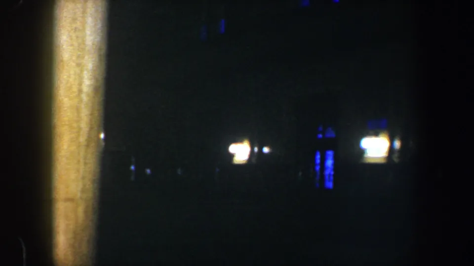 A dark outdoor Baltimore night view shows a vertical post and scattered blue-white lights, with furniture mostly out of frame.