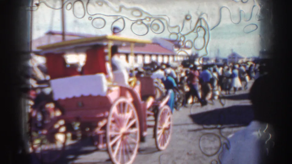 1961 Nassau street view with a red carriage in the foreground and a crowd extending toward the harbor area.