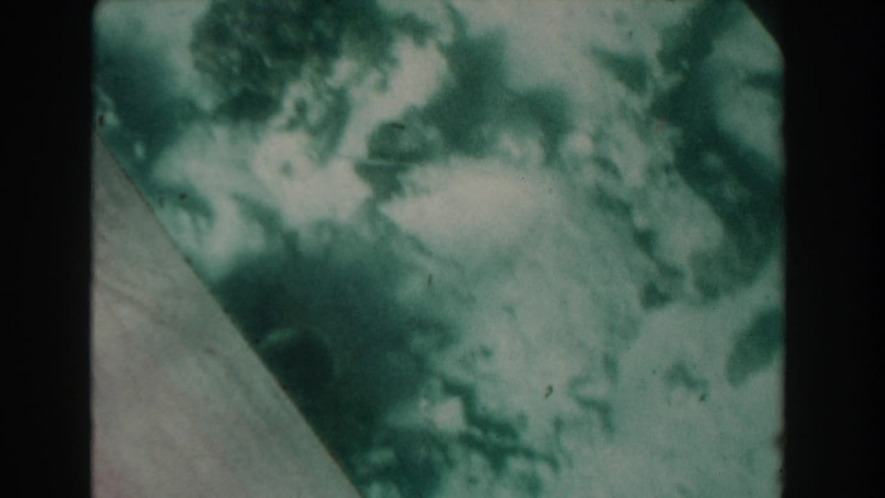 Cloudy underwater view with a diagonal glass edge and mottled green-blue light.