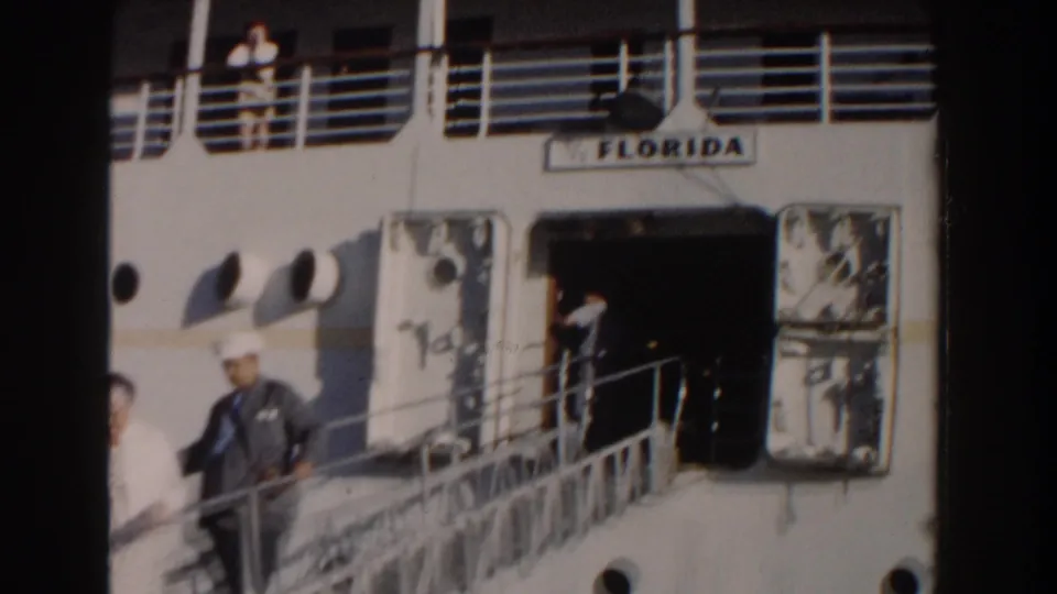 Close view of the ship's gangway in Nassau, with people on deck and the vessel name Florida visible near the entrance.