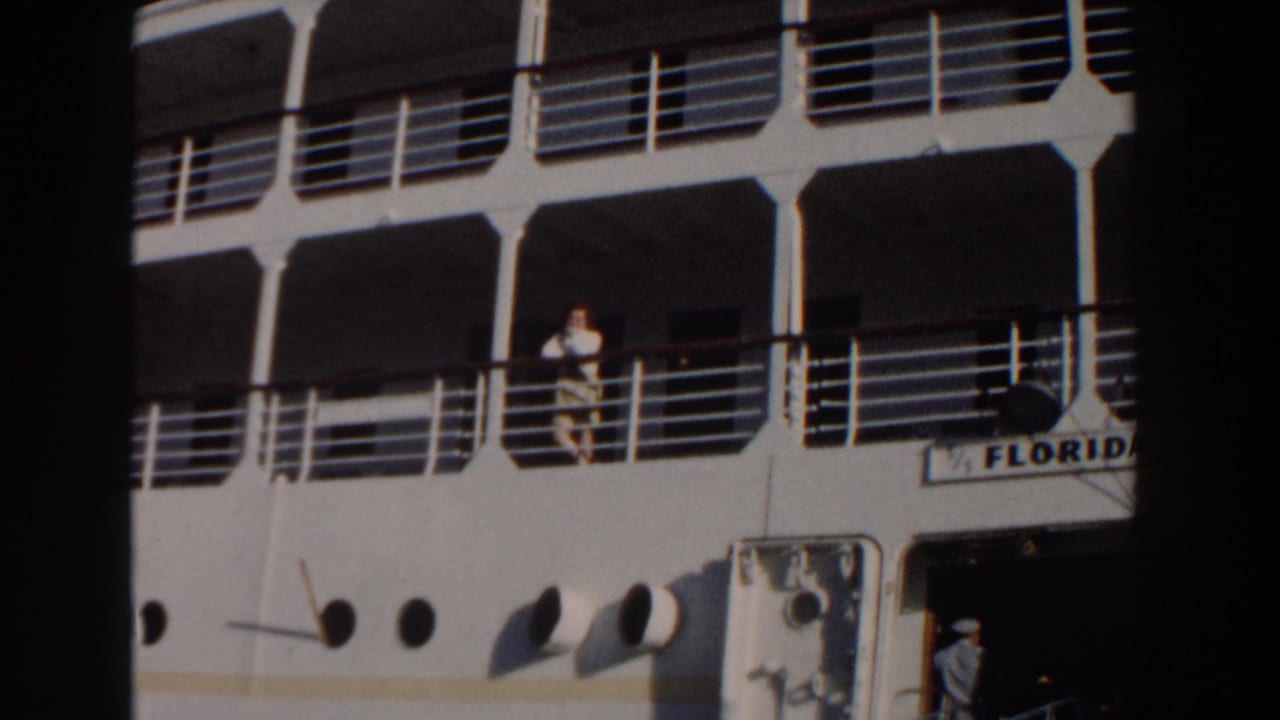 In Nassau, Bahamas in 1961, a woman stands on the deck railing area of the cruise ship Florida, with white decks and portholes visible.