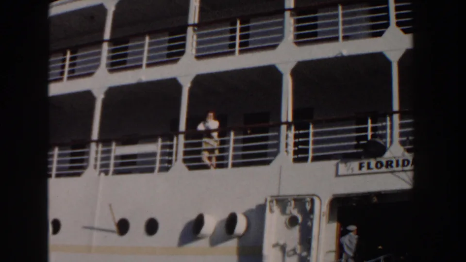 In Nassau, Bahamas in 1961, a woman stands on the deck railing area of the cruise ship Florida, with white decks and portholes visible.