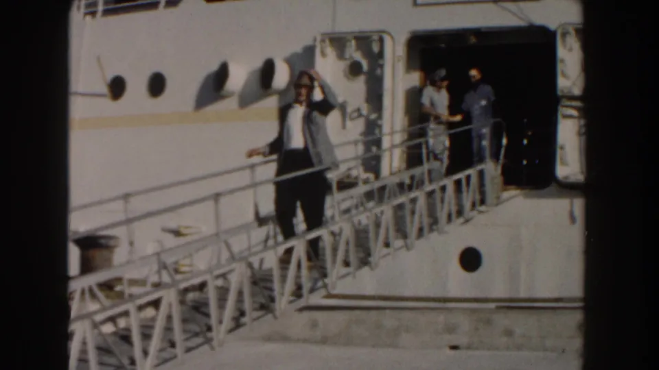 The 1961 Nassau ship scene shows the suited man waving again from the gangway, with crew and passengers framed by the open hatch.