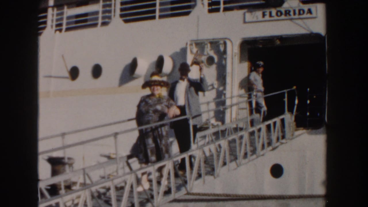 Elderly woman and man on a gangway beside a white ship marked FLORIDA.