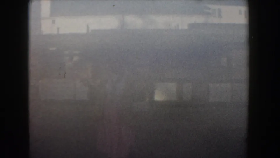 The final Nassau home-movie frame appears overexposed and soft, with faint outlines of the resort area visible through color fading and grain.