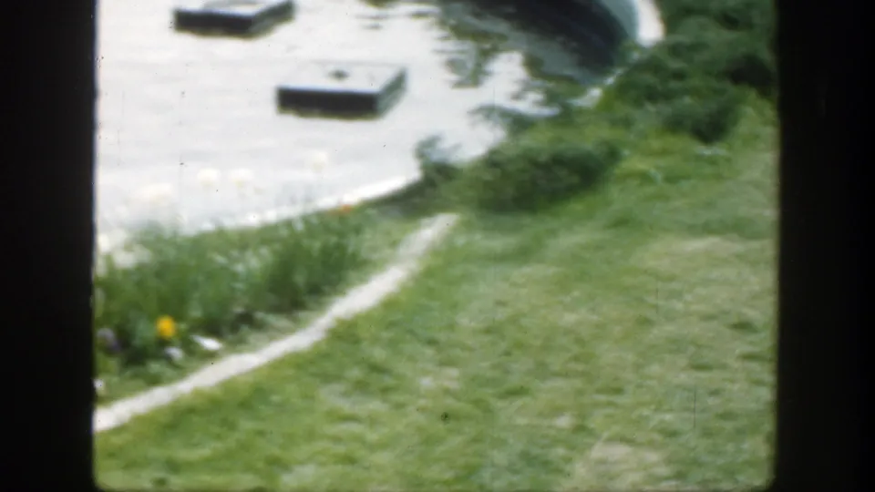 1949 Cincinnati park garden view with a curved path or border, pond water, mowed grass, and planted edge.