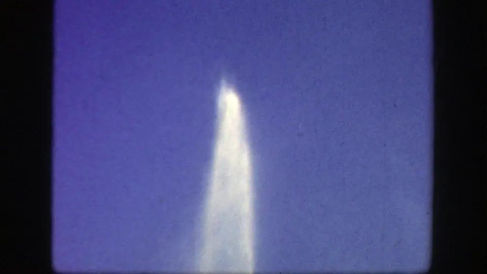 1949 Cincinnati 8mm frame showing a bright fountain plume rising high against a soft purple-blue sky.