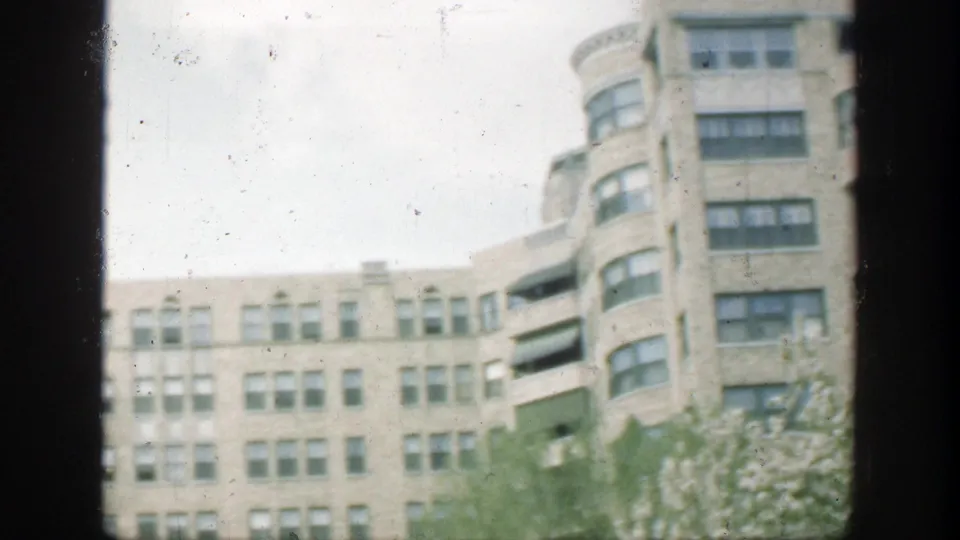 Cincinnati urban building exterior from 1949, framed by a dark vertical bar with rounded bays and many windows visible.