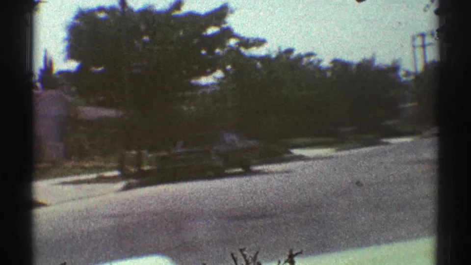 The final frame shows the moving approach passing trees, curb, sidewalk, and residential greenery in Woodland Hills, California.