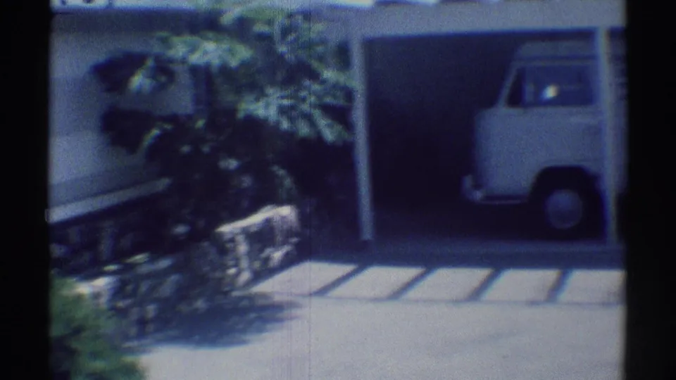 White Volkswagen-style van appears under a carport at a Woodland Hills residence in 1969 home-movie footage.