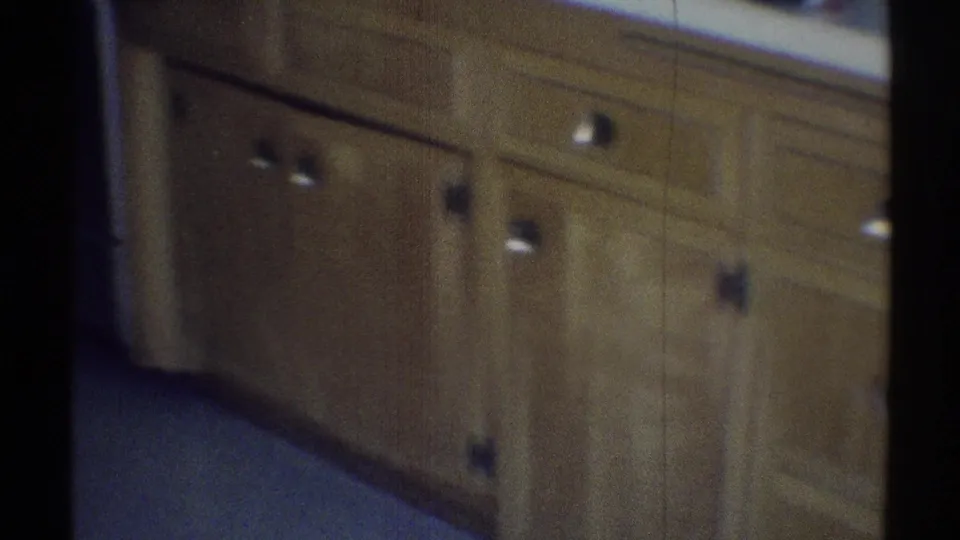 Woodland Hills 1969 kitchen detail with lower cabinets, drawers, round pulls, counter edge, and soft 8mm blur.
