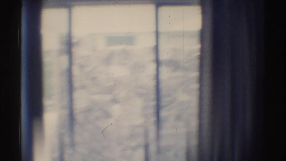 1969 Woodland Hills 8mm frame showing a bright interior window, vertical divisions, and an indistinct exterior beyond.