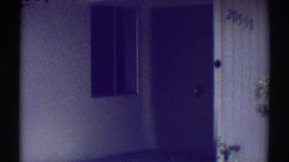 Residential exterior detail in Woodland Hills, showing a dark doorway, wall, window area, and visible number 20551.