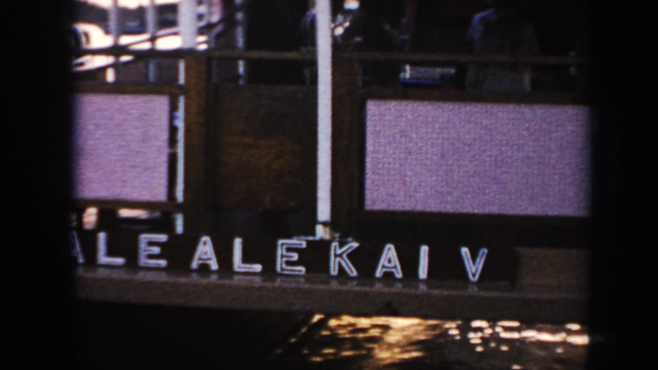 1961 Hawaii home-movie frame showing the Alekai V name on a docked vessel with railings and deck details above.