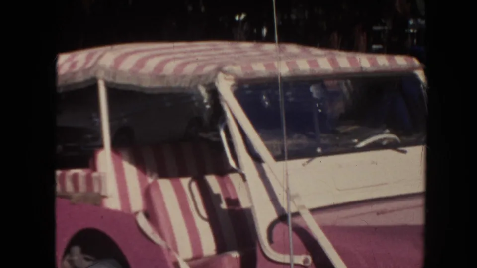 1961 Hawaii home-movie view of the jeep canopy, side seating, windshield frame, and sunlit hood.