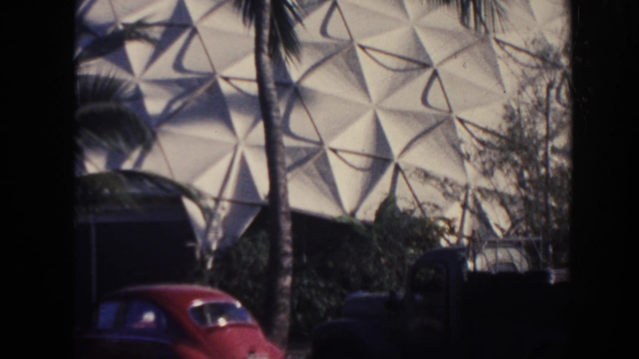 1961 Hawaii frame with palm trees and period cars in front of a white triangular dome-like exterior.