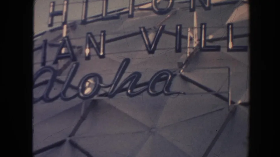 1961 Hawaii frame showing Hilton Hawaiian Village and Aloha signage in a close handheld composition.