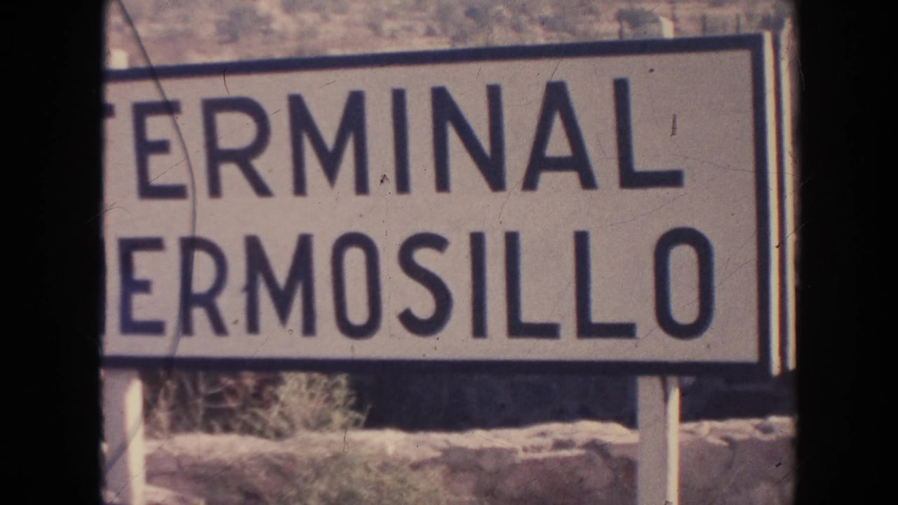 White sign reading Terminal Hermosillo beside a dry hillside.
