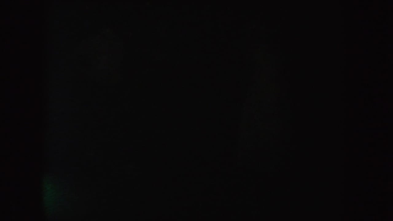 Final low-light 1954 South Dakota 8mm frame with nearly black exposure, faint texture, and no identifiable subject.