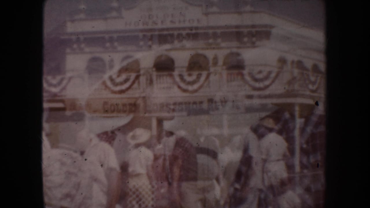 Crowd outside a bunting-decorated building with a Golden Horseshoe sign.