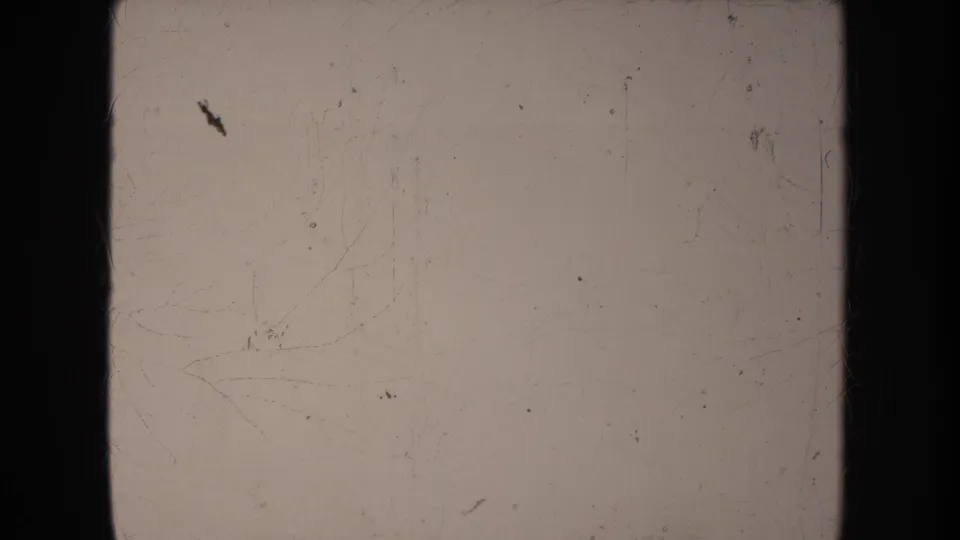 The final frame is mostly pale and overexposed, showing film scratches, dust, and edge shadow with no clear subject visible.