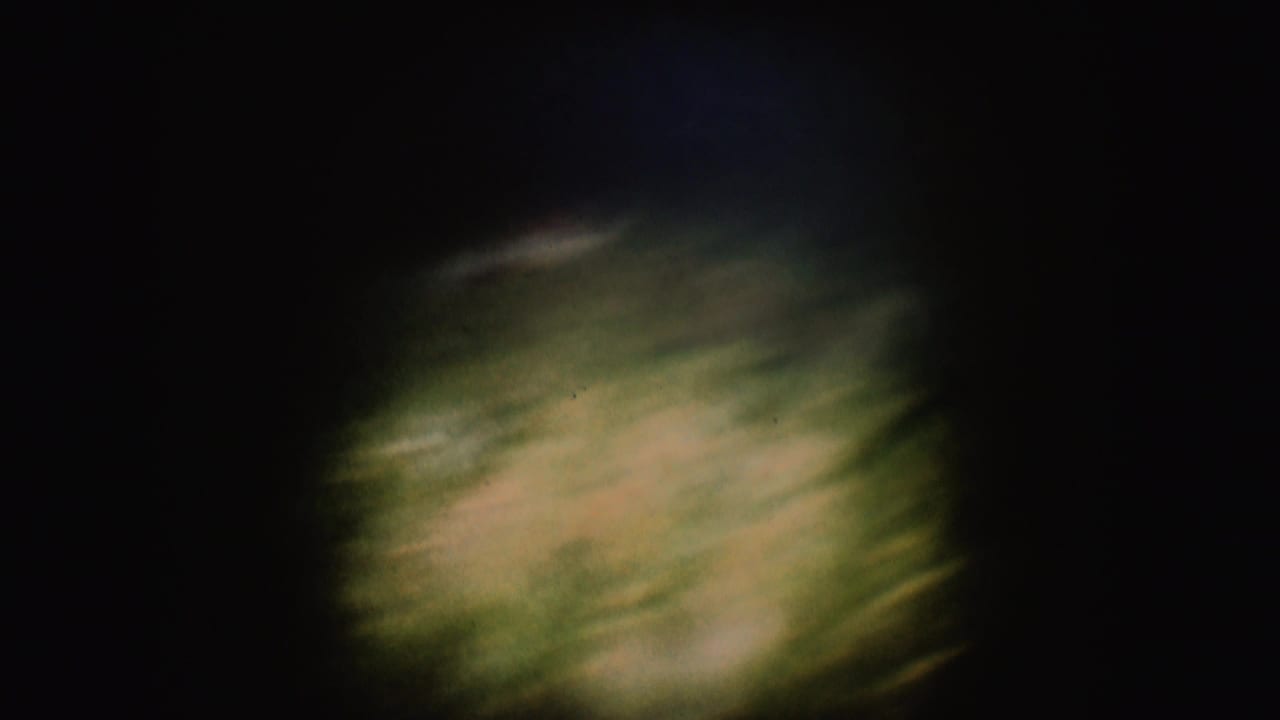 End frame from the 8mm clip showing blurred water or wake detail, with the tow scene no longer clearly visible.