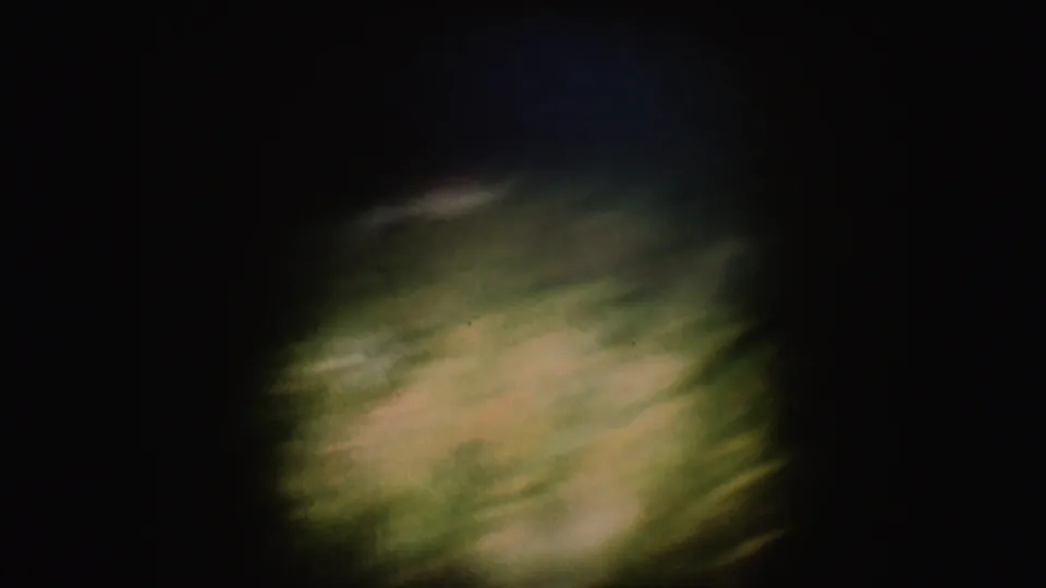 End frame from the 8mm clip showing blurred water or wake detail, with the tow scene no longer clearly visible.
