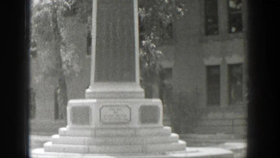 1939 Wyoming 8mm frame revealing the memorial monument from top to stepped base, with an unreadable engraved panel near the bottom.