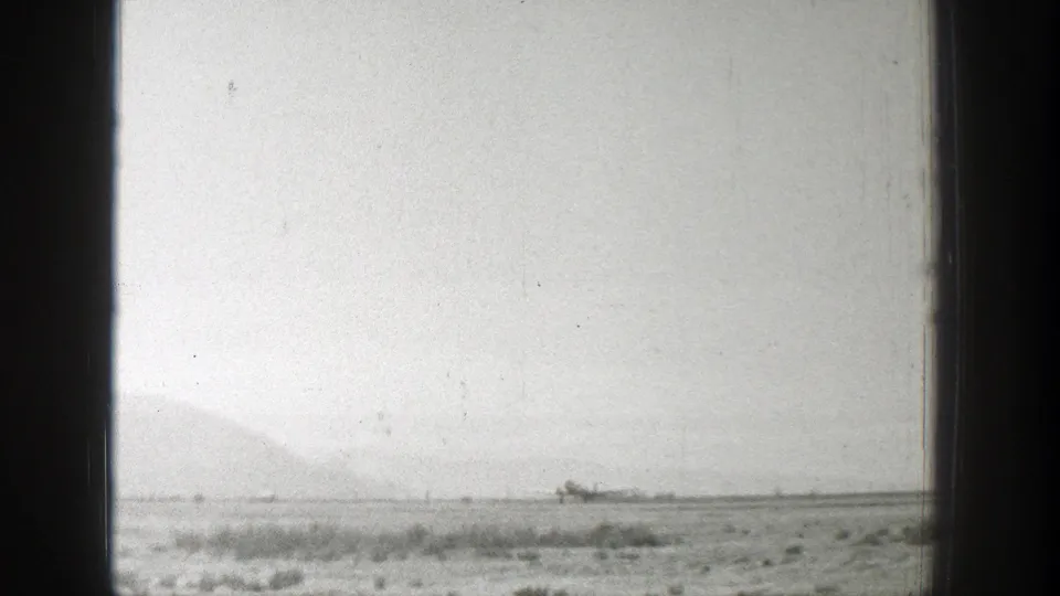 Final 1939 Wyoming frame shifts away from the building to an open arid plain under a pale sky.