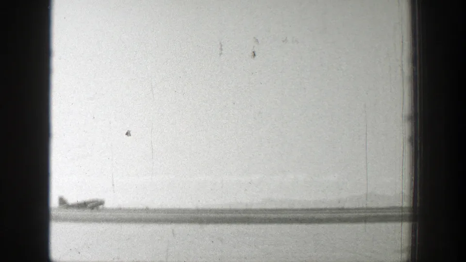 Final 1939 Wyoming frame showing the distant Army airplane low over the airfield after takeoff.