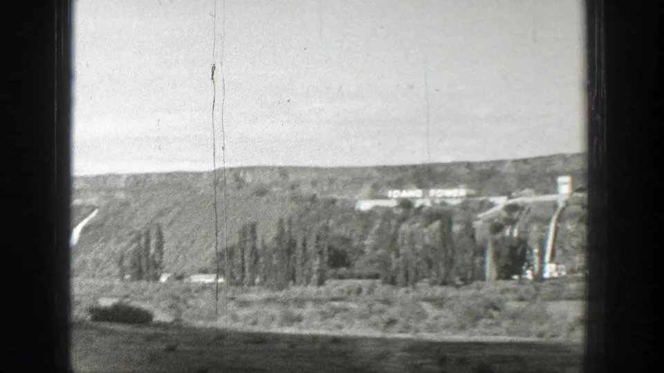 1939 Wyoming 8mm frame showing a dam or utility complex with Idaho Power lettering visible on a distant hillside or structure.