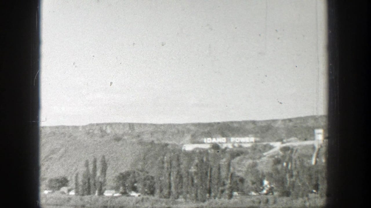 1939 Wyoming home-movie view of a distant hillside, valley trees, road, and Idaho Power lettering near the ridge.
