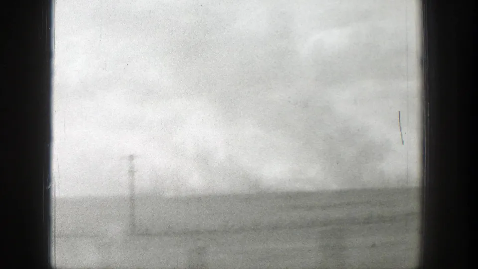 1939 Wyoming view of an open field or roadside with a low horizon, cloudy sky, and one visible utility pole.
