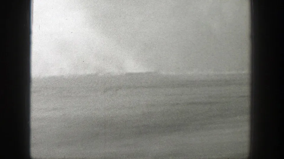 Black-and-white 8mm frame of a smoky Wyoming field horizon in 1939, softened by grain and exposure haze.