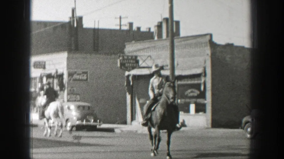 The final 1939 Wyoming frame shows a cowboy-hatted rider on a dark horse facing camera, with storefronts, a car, and signage behind.