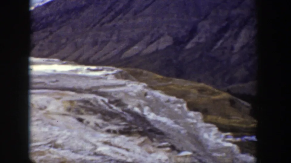Wyoming mountain attraction detail showing pale layered rock, a sloping hillside, and grassy ground in 1939 8mm footage.