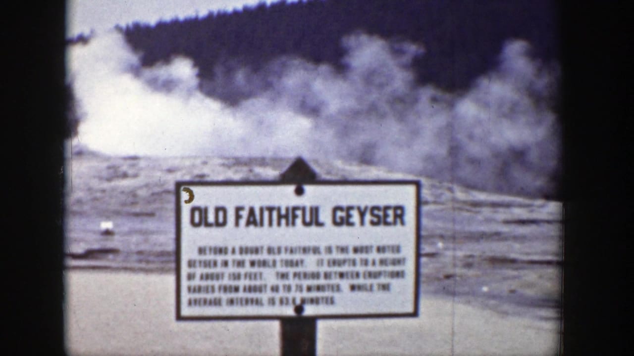The Old Faithful Geyser sign remains centered as steam spreads across the Yellowstone basin behind it.