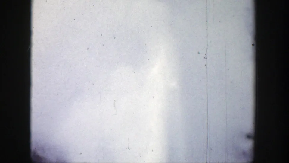 1939 Wyoming 8mm frame showing a soft white column of geyser spray against a pale sky with visible film wear.