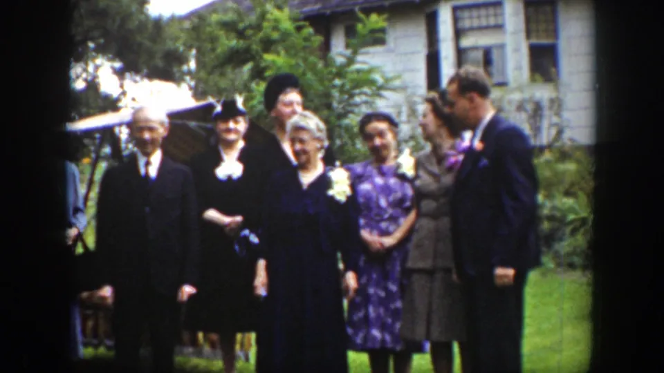 The Wyoming 1939 scene shows a close formal group pose with suited men, women in hats, corsages, and garden foliage.